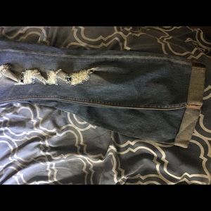 Distressed jeans cuffed at the bottom